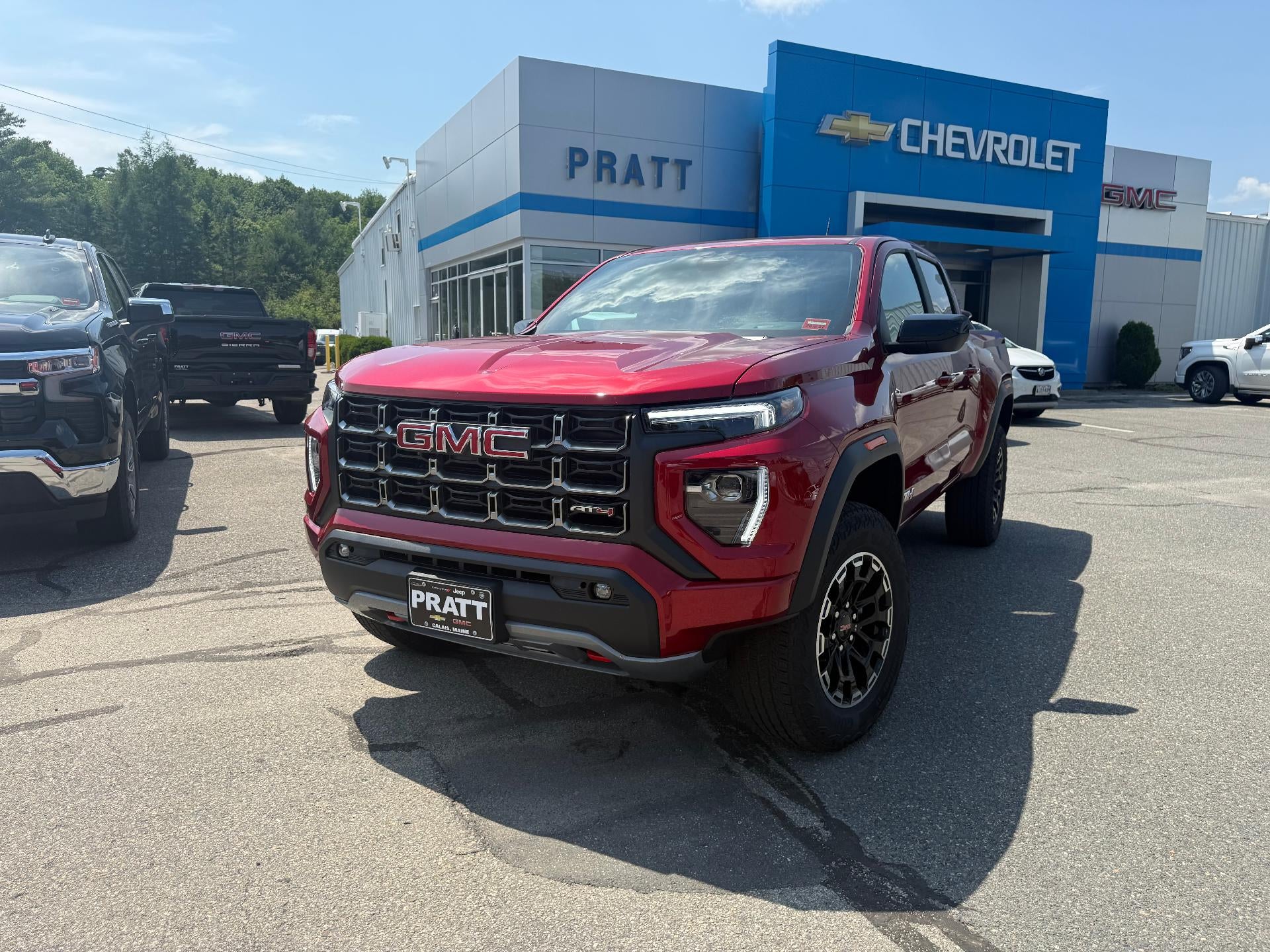 2026 GMC Canyon AT4, 4WD in Volcanic Red Tintcoat — front three-quarter view